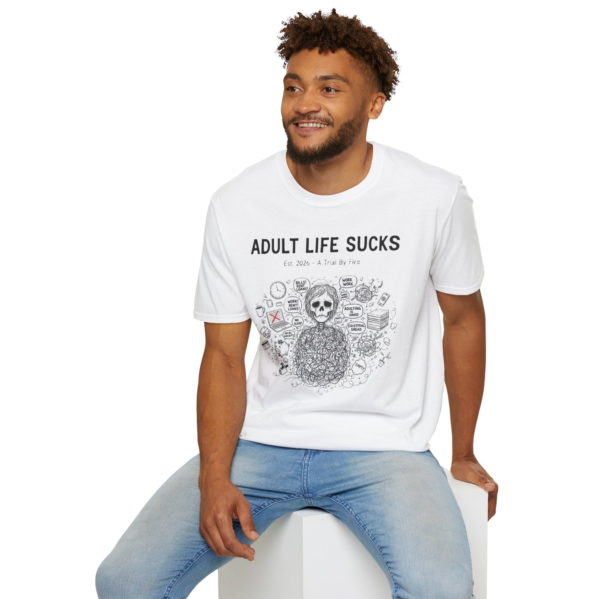 Man wearing a white t-shirt with 'Adult Life Sucks' text and graphics, sitting on a white stool.