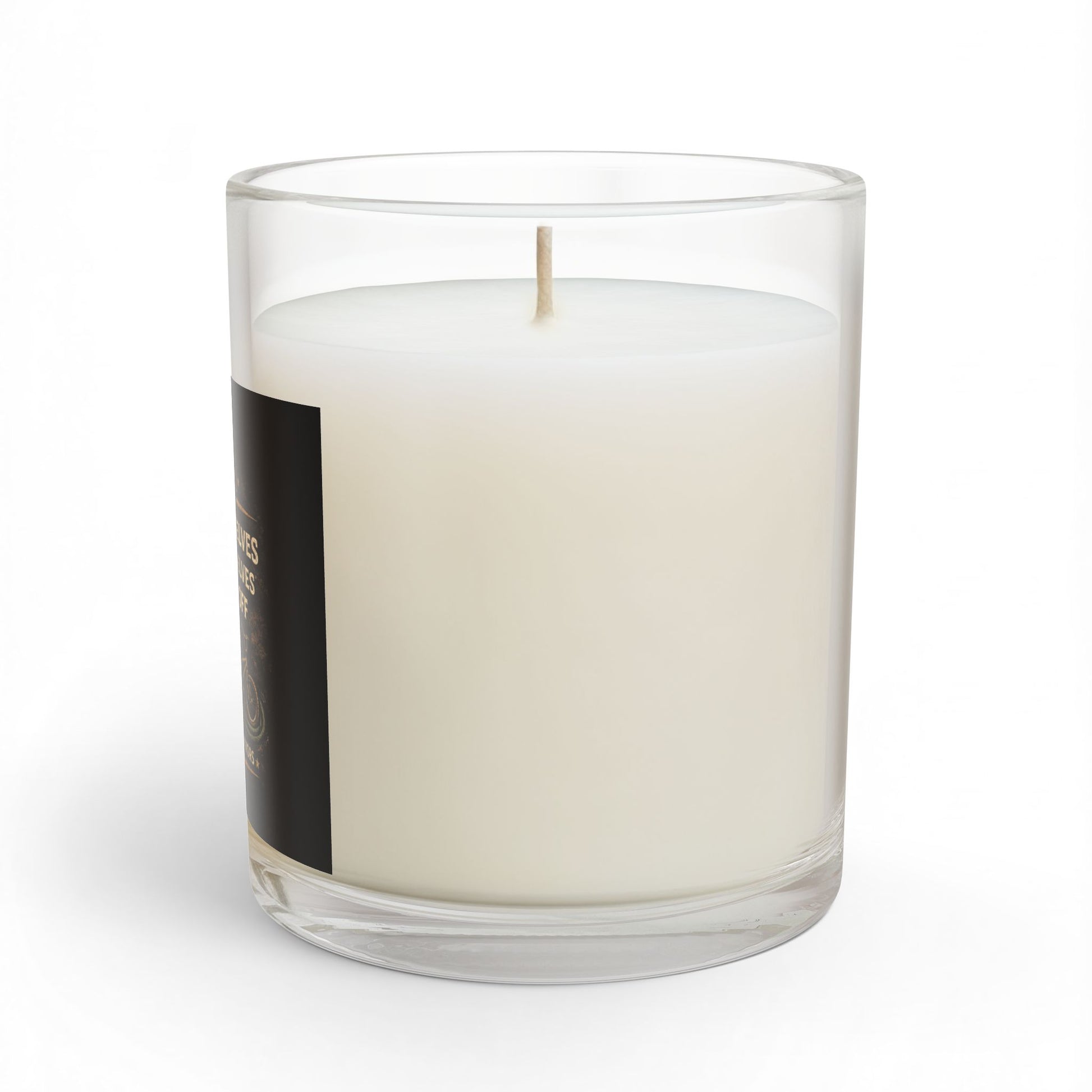 White candle in a clear glass container with a black label on a white background