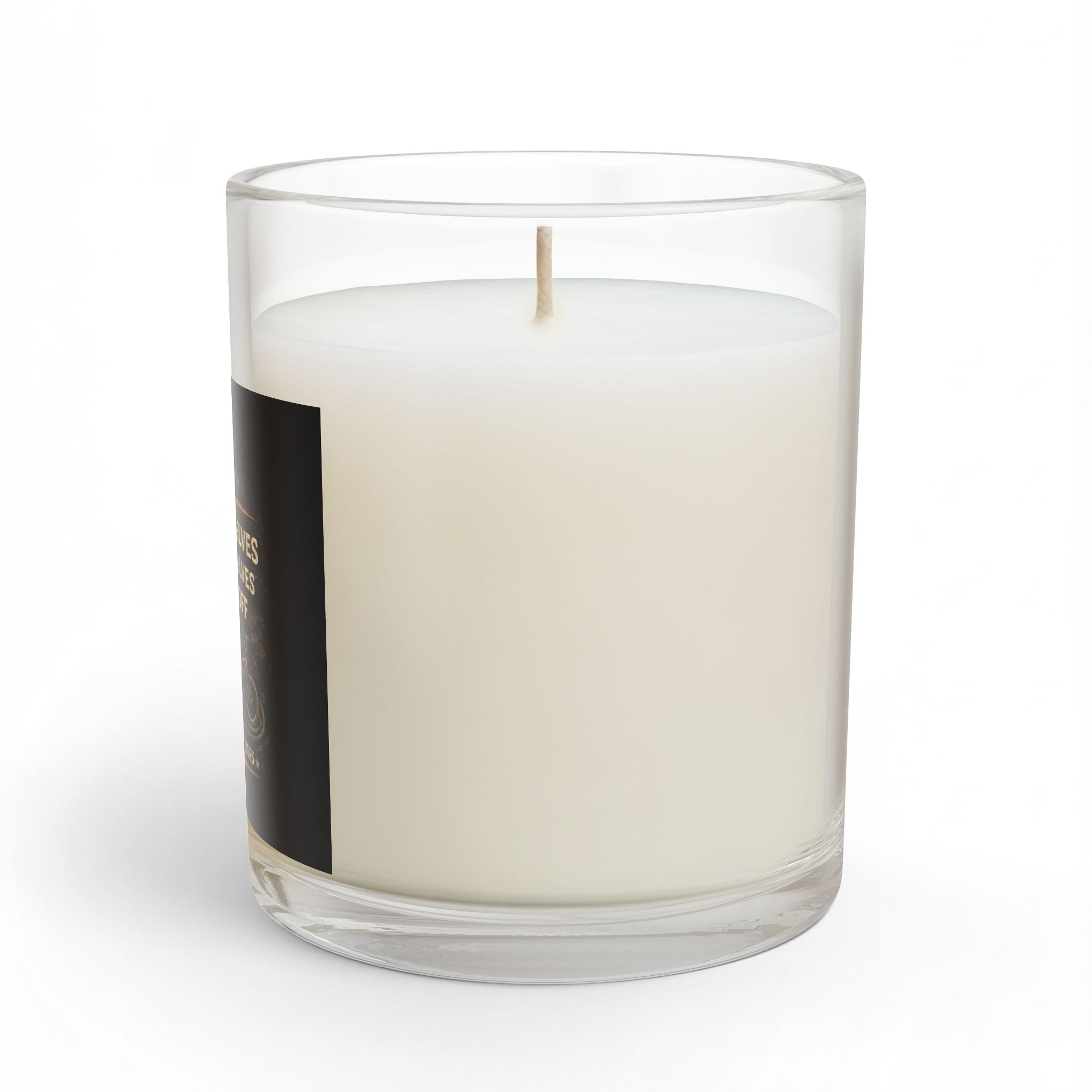 White candle in a clear glass container with a black label on a white background