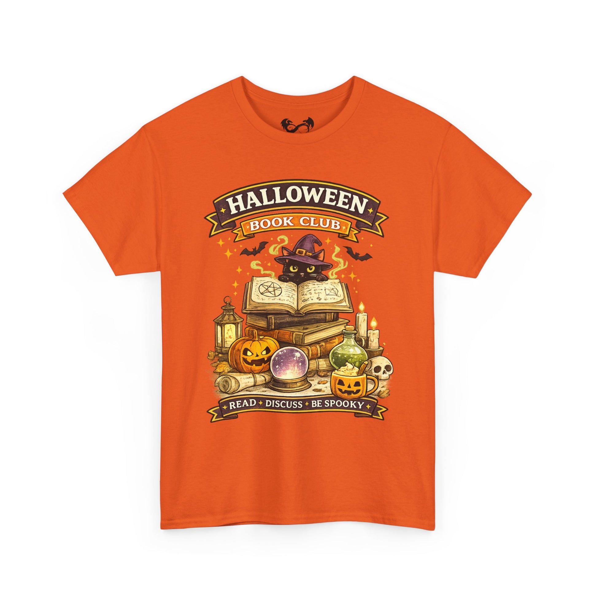 An orange short-sleeve crewneck t-shirt featuring a colorful graphic print on the front with the text 'HALLOWEEN BOOK CLUB' and a spooky illustration of books, pumpkins, a cauldron, and a cat in a witch hat.