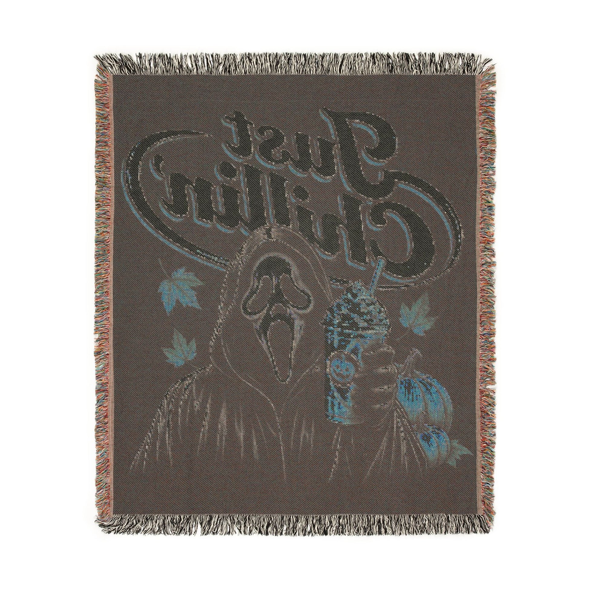 A dark brown woven throw blanket with fringe on all sides, featuring a graphic design with a deer head, blue leaves, and stylized text reading 'Chillin' Just'.
