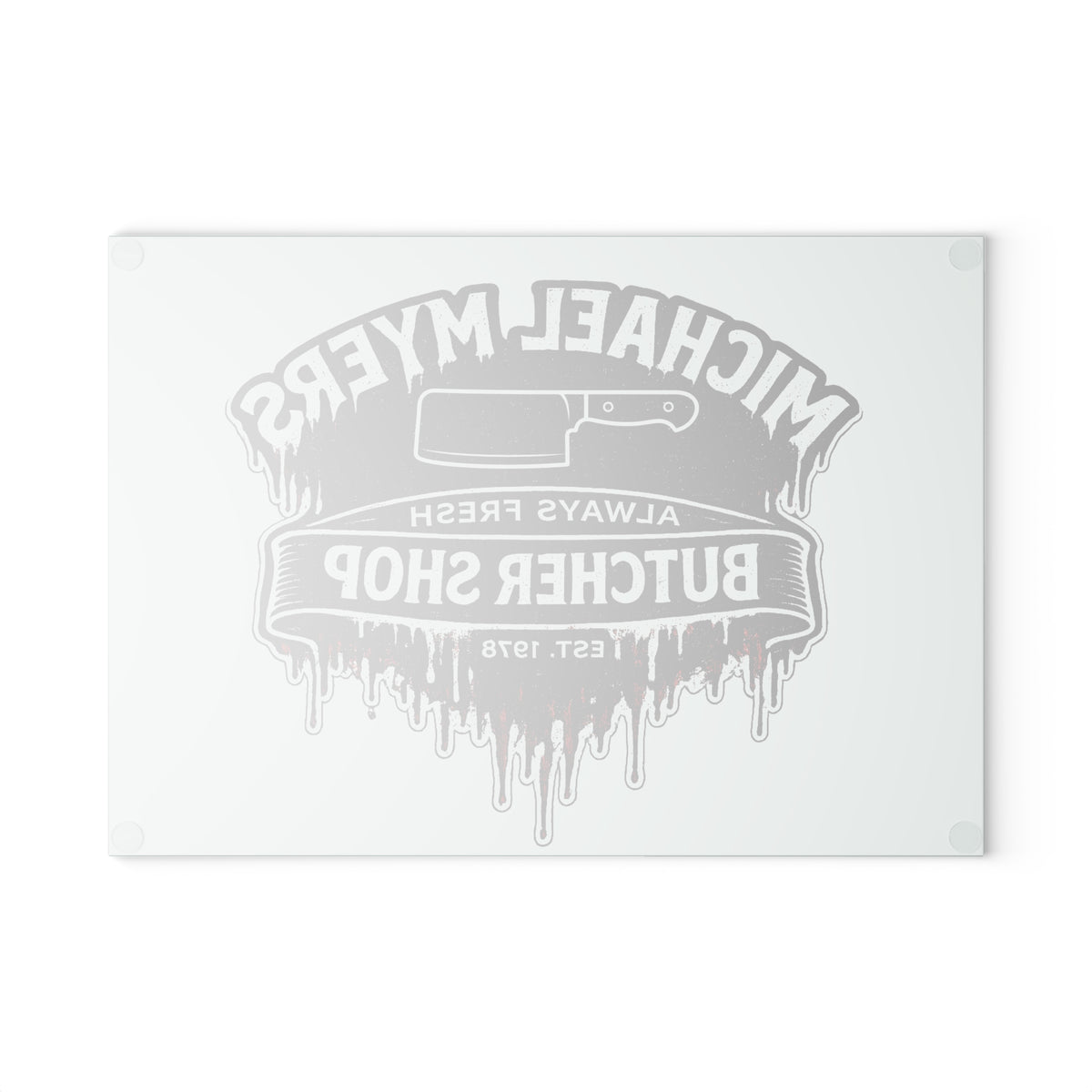 A rectangular white cutting board with rounded corners, featuring a gray dripping butcher shop graphic with a cleaver illustration and the text 'Michael Myers Butcher Shop' and 'Always Fresh'.