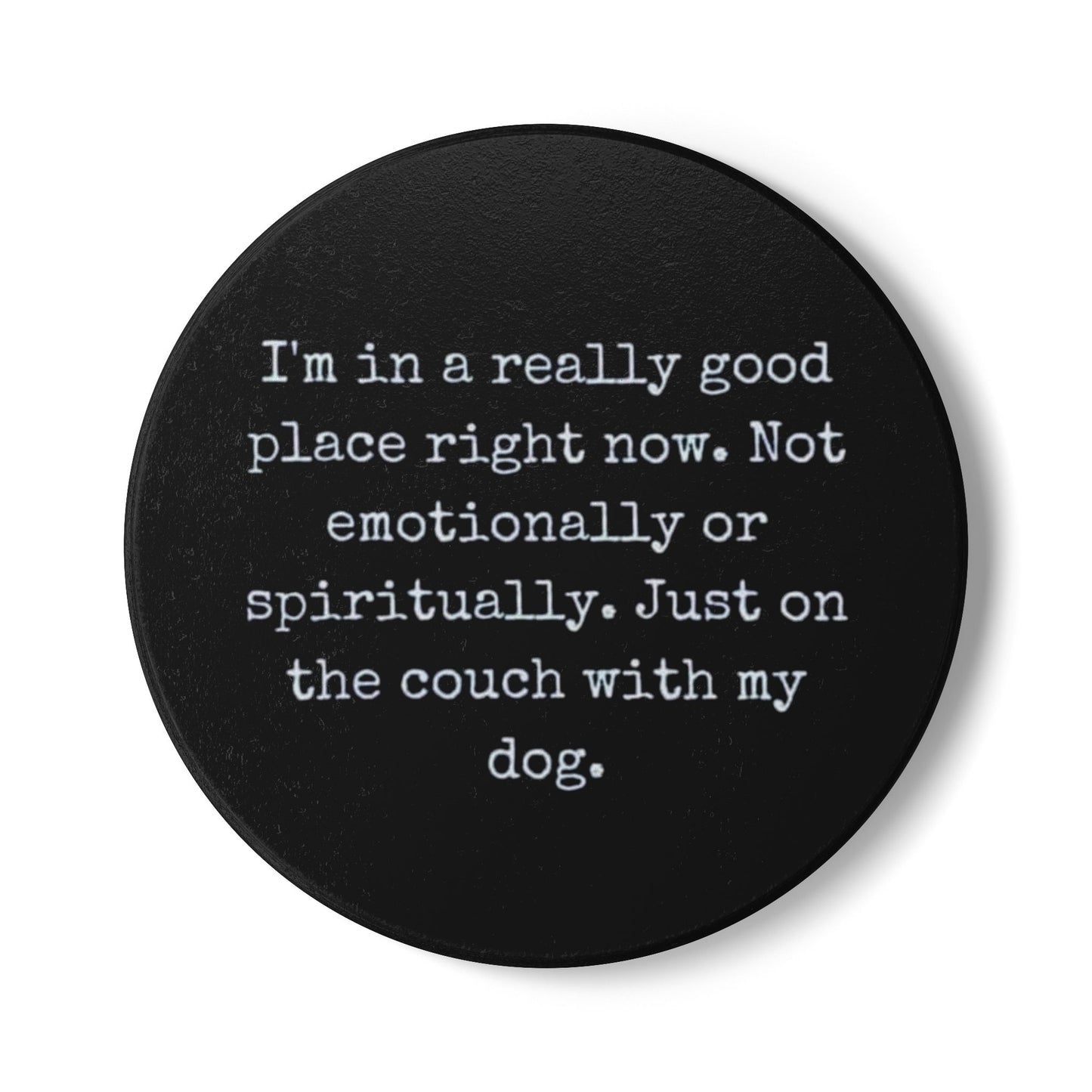 Black round coaster with white text on a white background