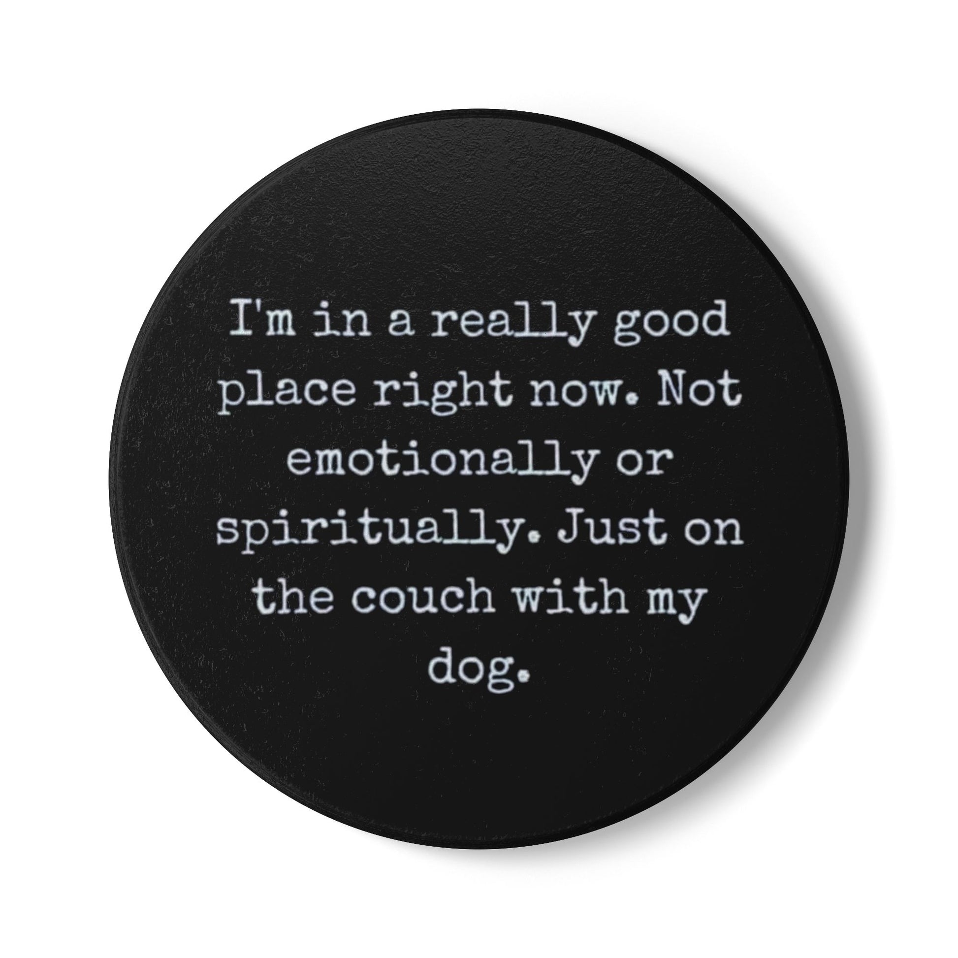 Black round coaster with white text on a white background