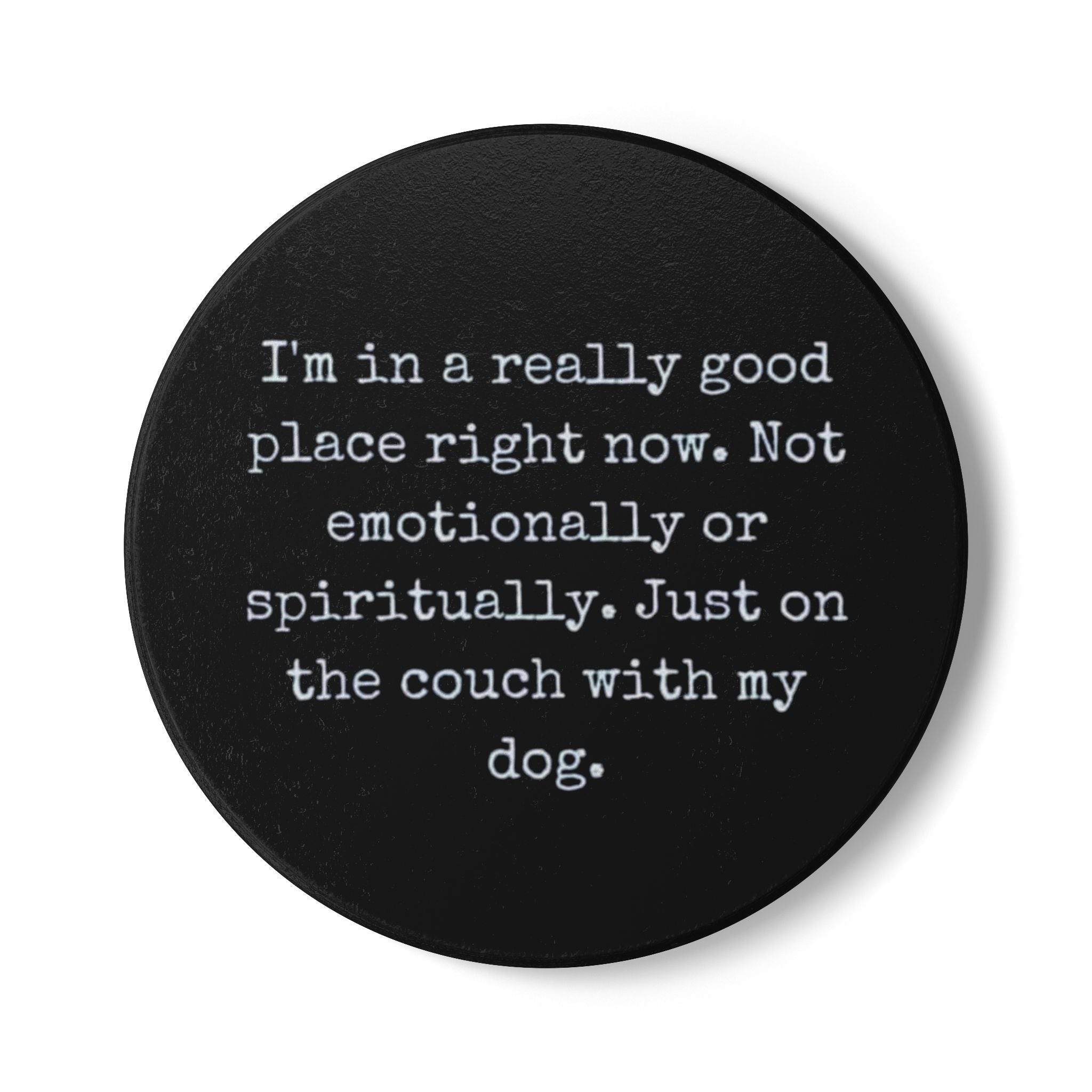 Black round coaster with white text on a white background