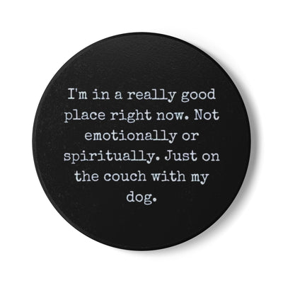 Black round coaster with white text on a white background