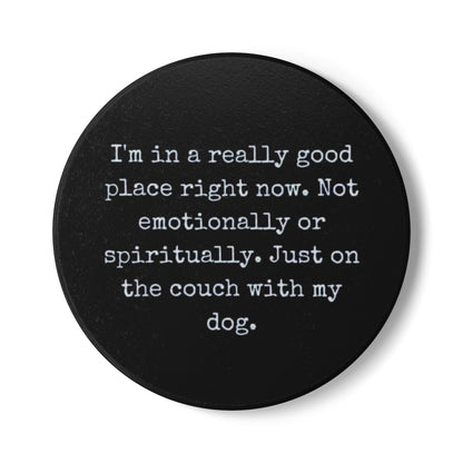 Black round coaster with white text on a white background