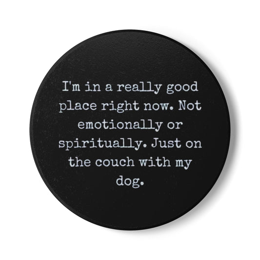 Black round coaster with white text on a white background