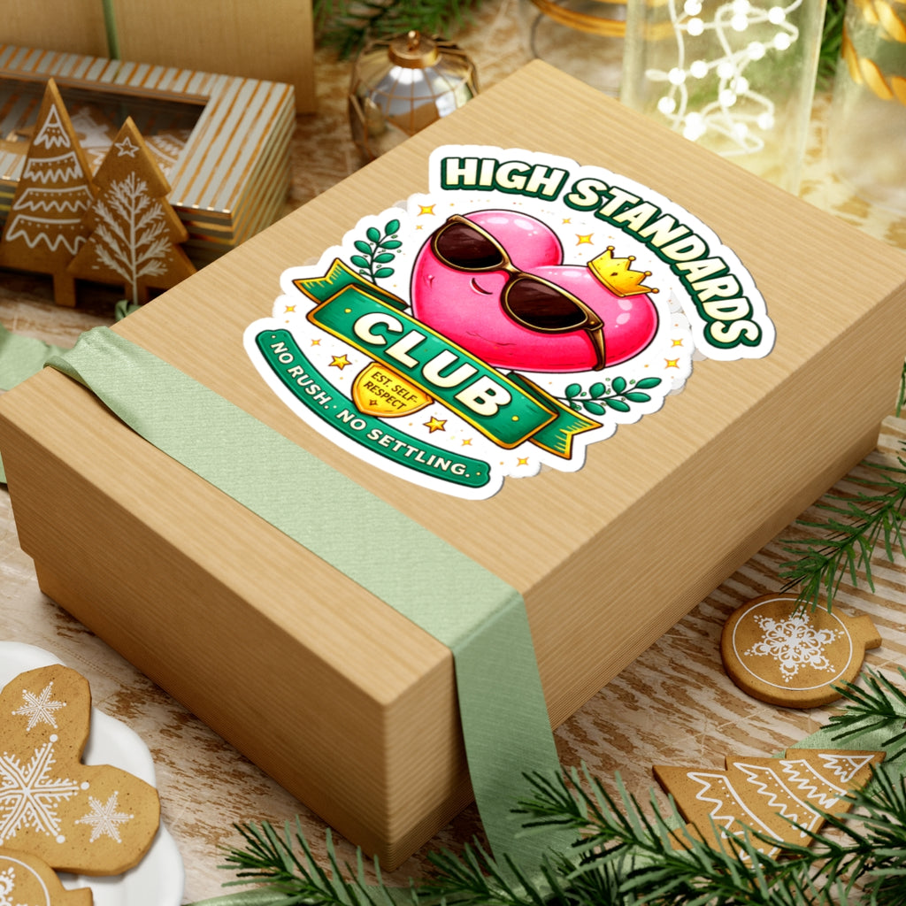 Wooden gift box with a 'High Standards Club' sticker on a festive background with cookies and decorations.