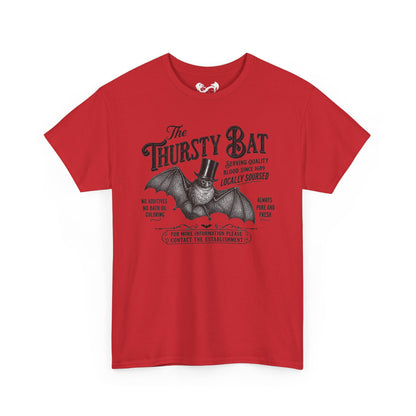 A red short-sleeve crewneck t-shirt featuring a vintage-style graphic of a bat wearing a top hat with the text 'The Thirsty Bat' and additional humorous text, shown on a plain white background.
