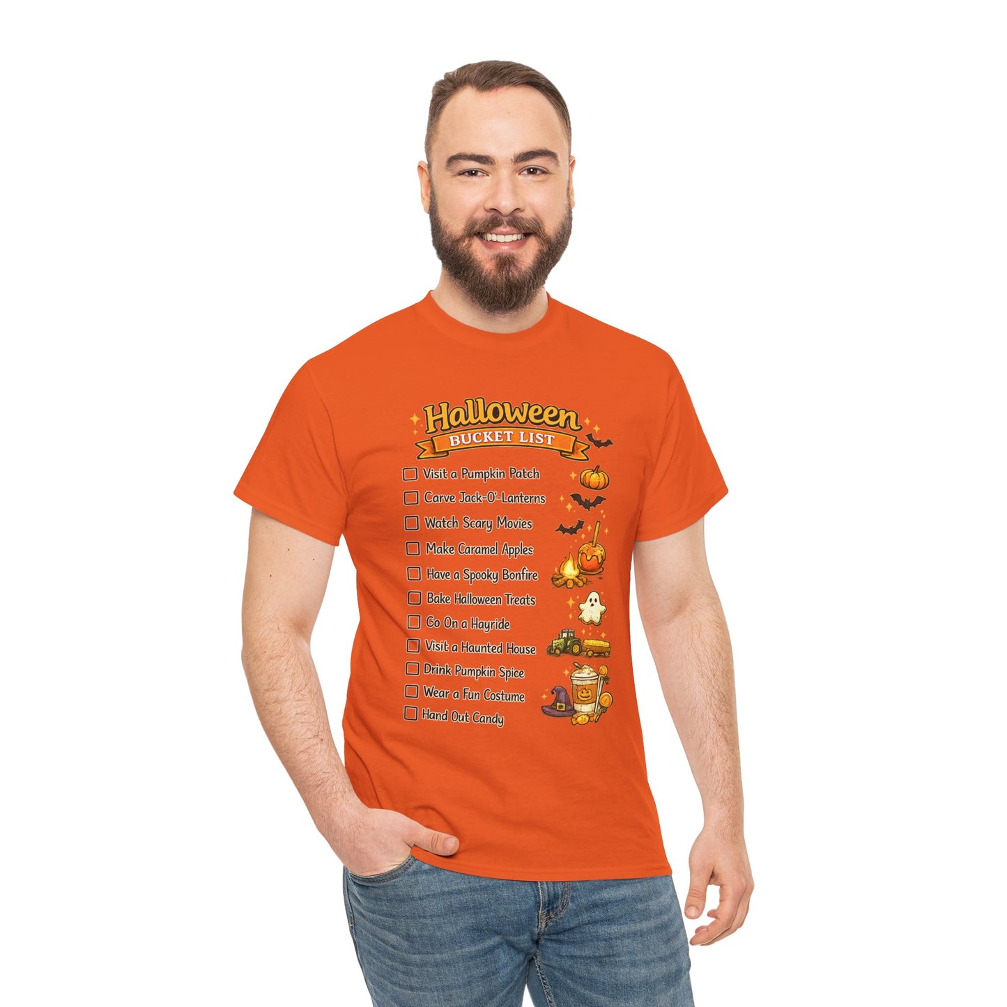 A man wearing a bright orange graphic t-shirt with a 'Halloween Bucket List' checklist and illustrations, paired with blue jeans, against a plain white background.