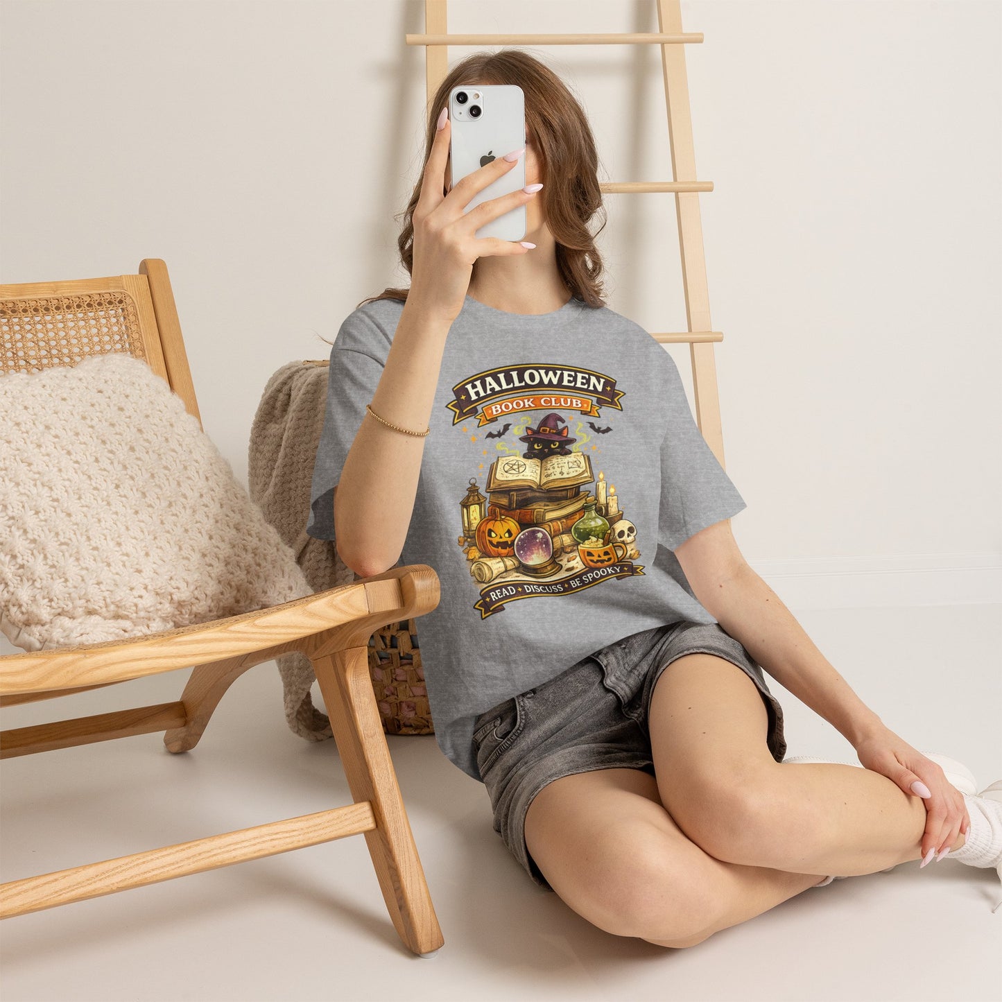 Person wearing a green t-shirt with a graphic design sitting on the floor.