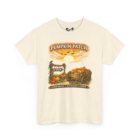 An off-white short-sleeve t-shirt with a vintage-style autumn graphic on the front that reads 'Pumpkin Patch' above a sunset scene with pumpkins, a wagon, and a sign.