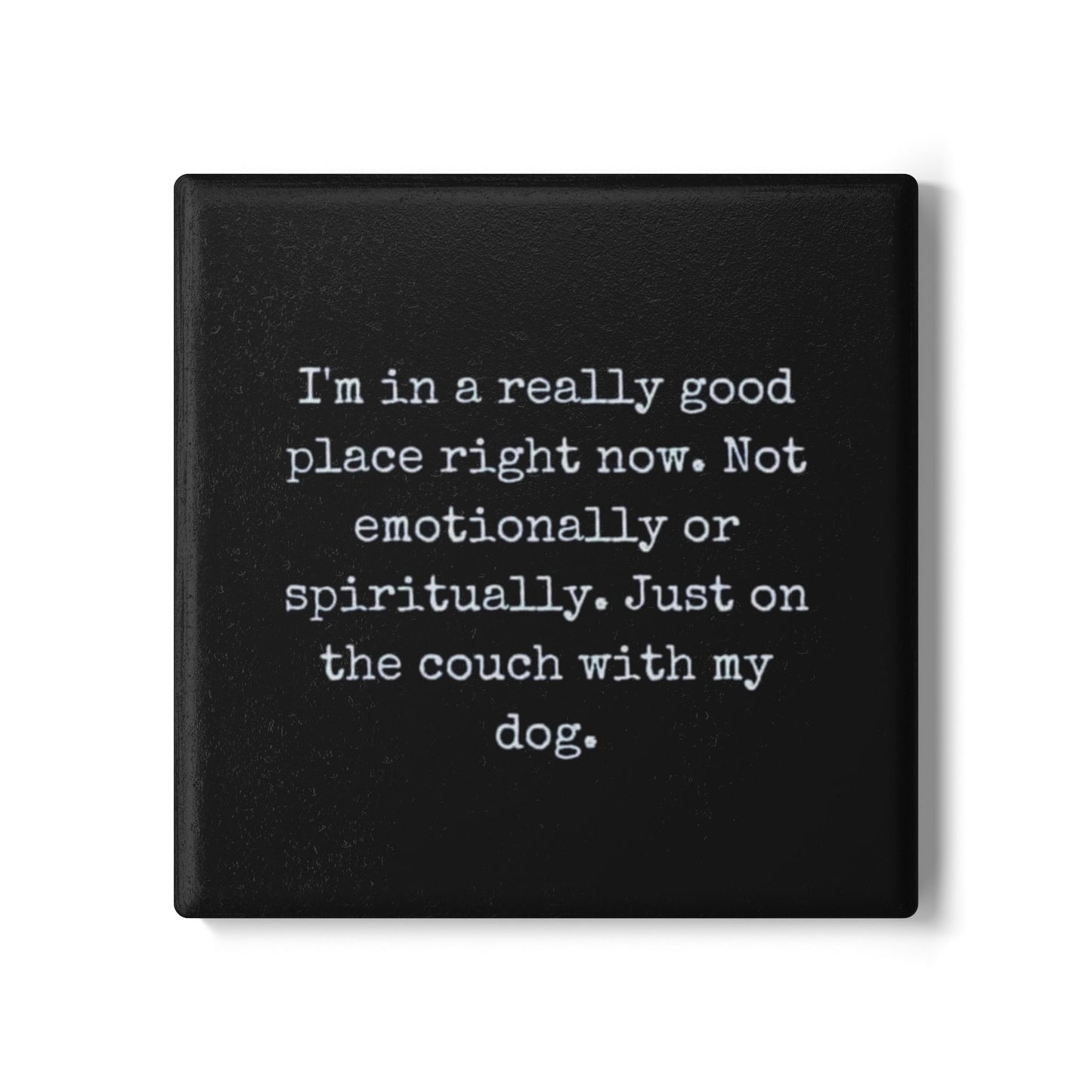 Black square coaster with white text on a white background