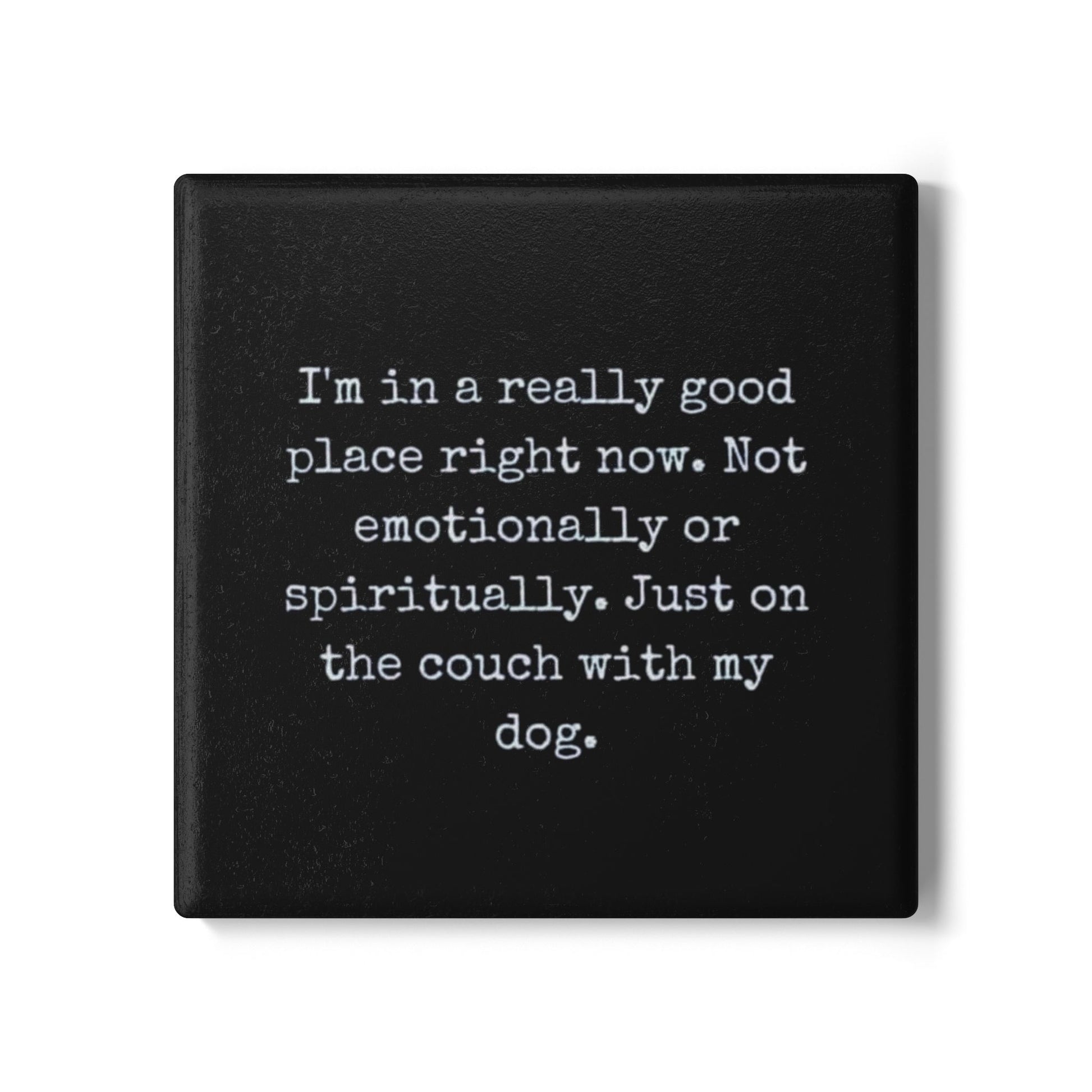 Black square coaster with white text on a white background
