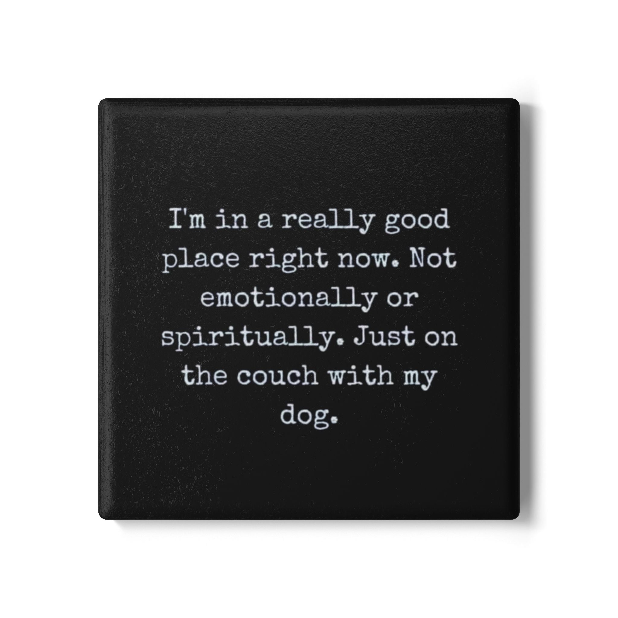 Black square coaster with white text on a white background
