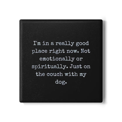 Black square coaster with white text on a white background