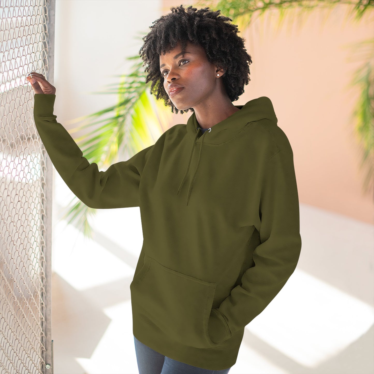 Person wearing a green hoodie with a blue flower design outdoors