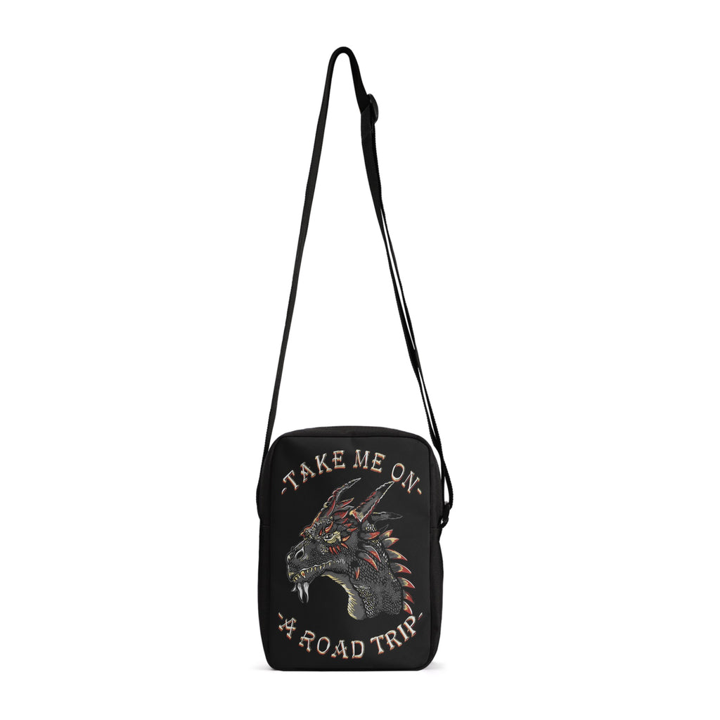 Take your style on the go with the Dragon Road Trip Cross-Body Bag, featuring bold dragon iconography and a spacious interior. This stylish bag has adjustable straps, so you can find your perfect fit effortlessly, while the secure zip-fastening will keep your items safe