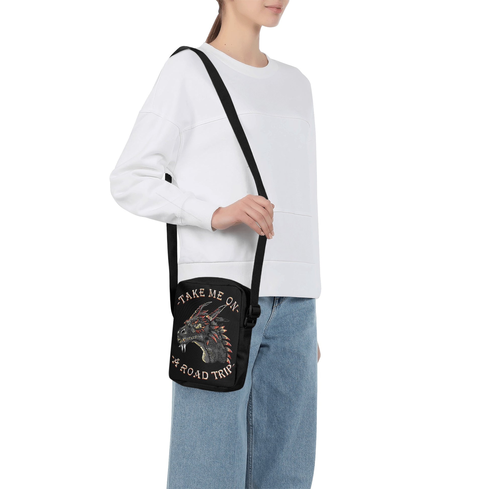 Take your style on the go with the Dragon Road Trip Cross-Body Bag, featuring bold dragon iconography and a spacious interior. This stylish bag has adjustable straps, so you can find your perfect fit effortlessly, while the secure zip-fastening will keep your items safe