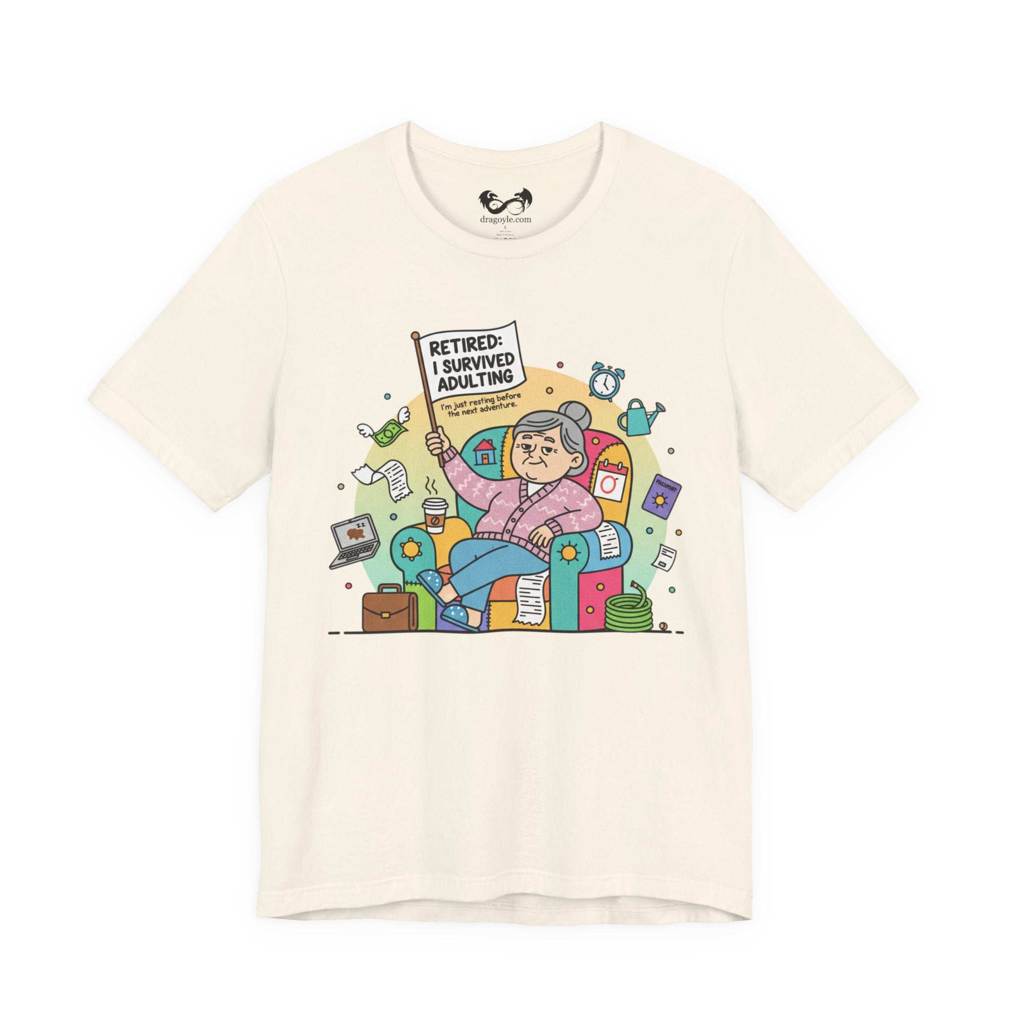 Beige t-shirt with a colorful graphic of a retired person holding a sign and sitting on a couch, on a white background.