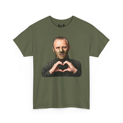 An olive green short-sleeve t-shirt with a graphic print of a man wearing a zombie mask and making a heart shape with his hands, displayed on a clean white background.