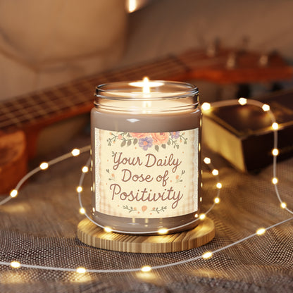 Candle in a jar with 'Your Daily Dose of Positivity' text, surrounded by string lights and a guitar in the background.