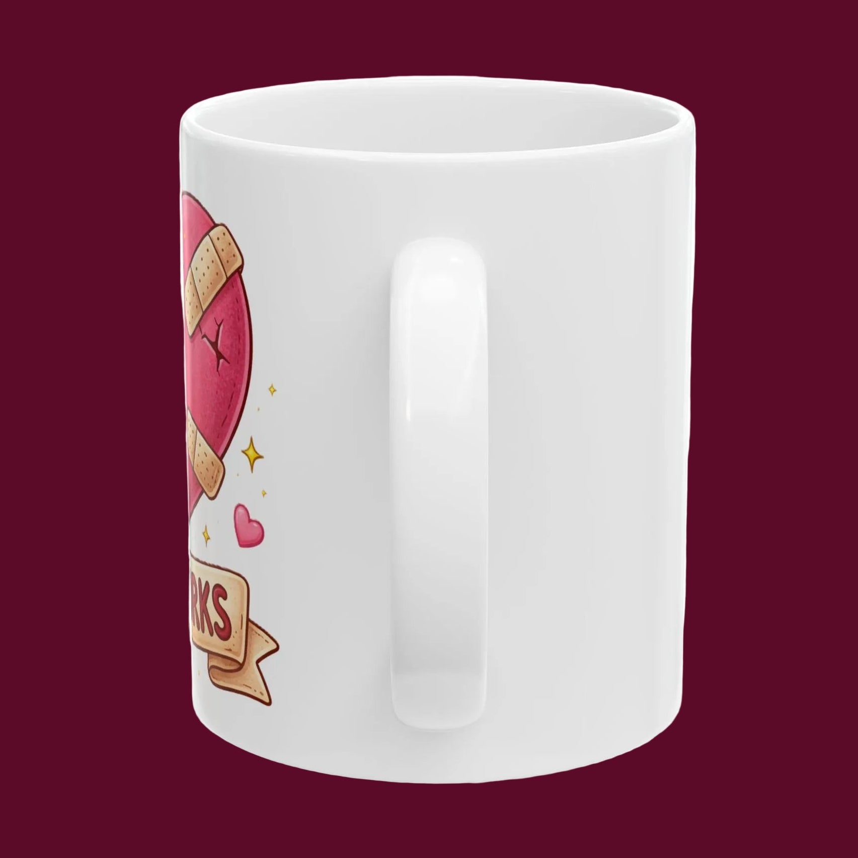 White mug with a pink heart and ribbon design on a dark red background