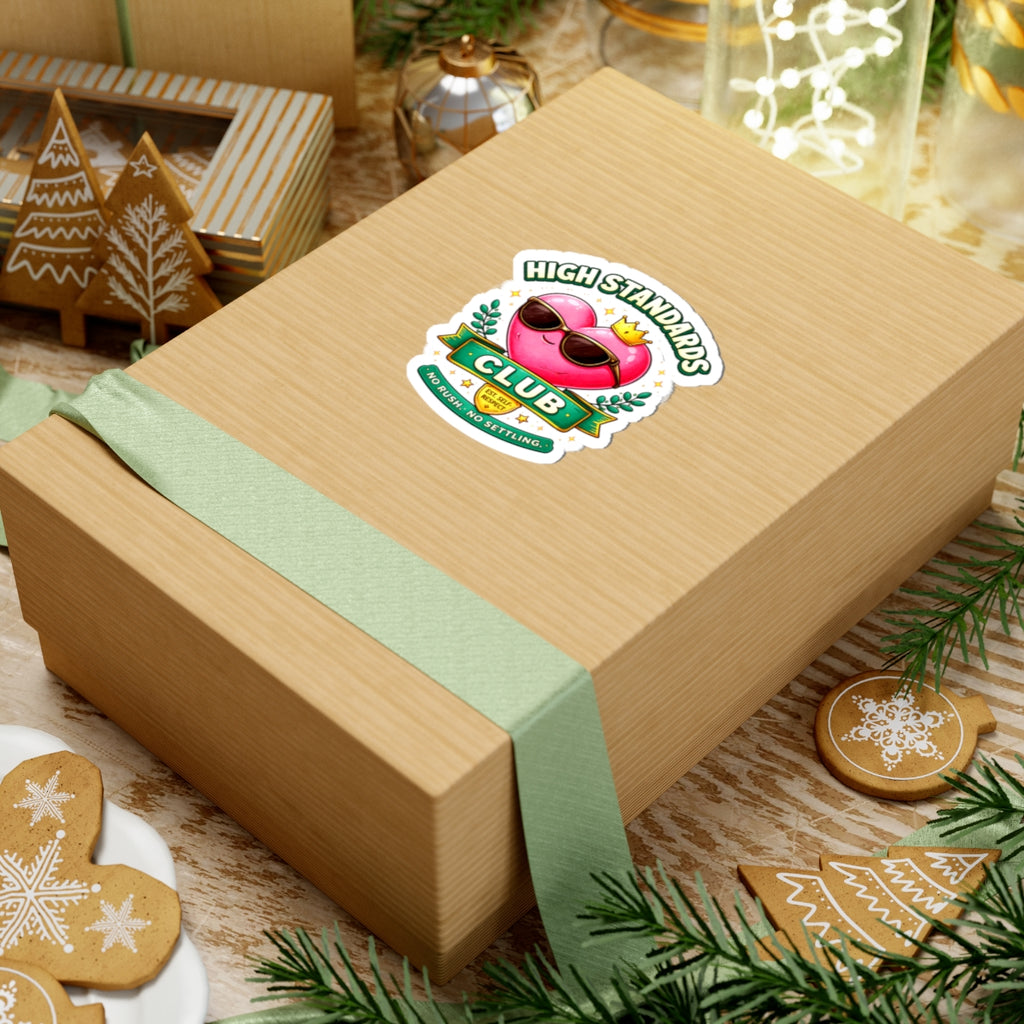 Wooden gift box with a green ribbon and a sticker on a festive background with cookies and lights.
