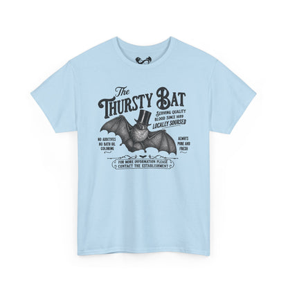 A light blue short-sleeve t-shirt with a vintage-style black graphic of a bat wearing a top hat and the text 'The Thirsty Bat'.