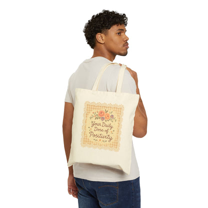 Man carrying a tote bag with text and floral design on a white background