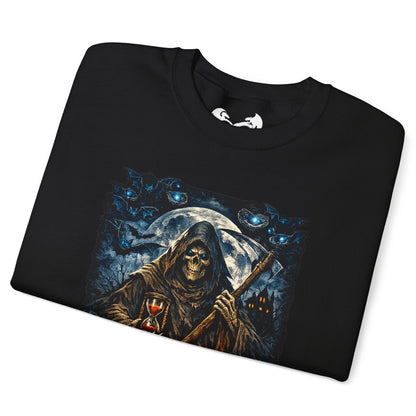 A black folded t-shirt with a detailed graphic print of a grim reaper holding a scythe in front of a full moon, surrounded by blue cats, shown on a plain white background.