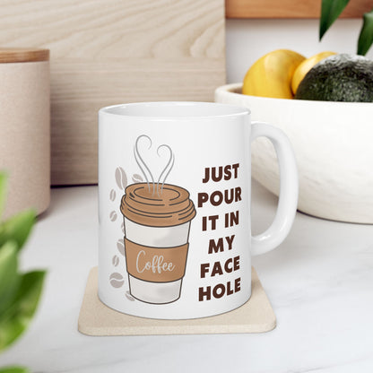 White mug with coffee graphic and text on a coaster, surrounded by kitchen items.