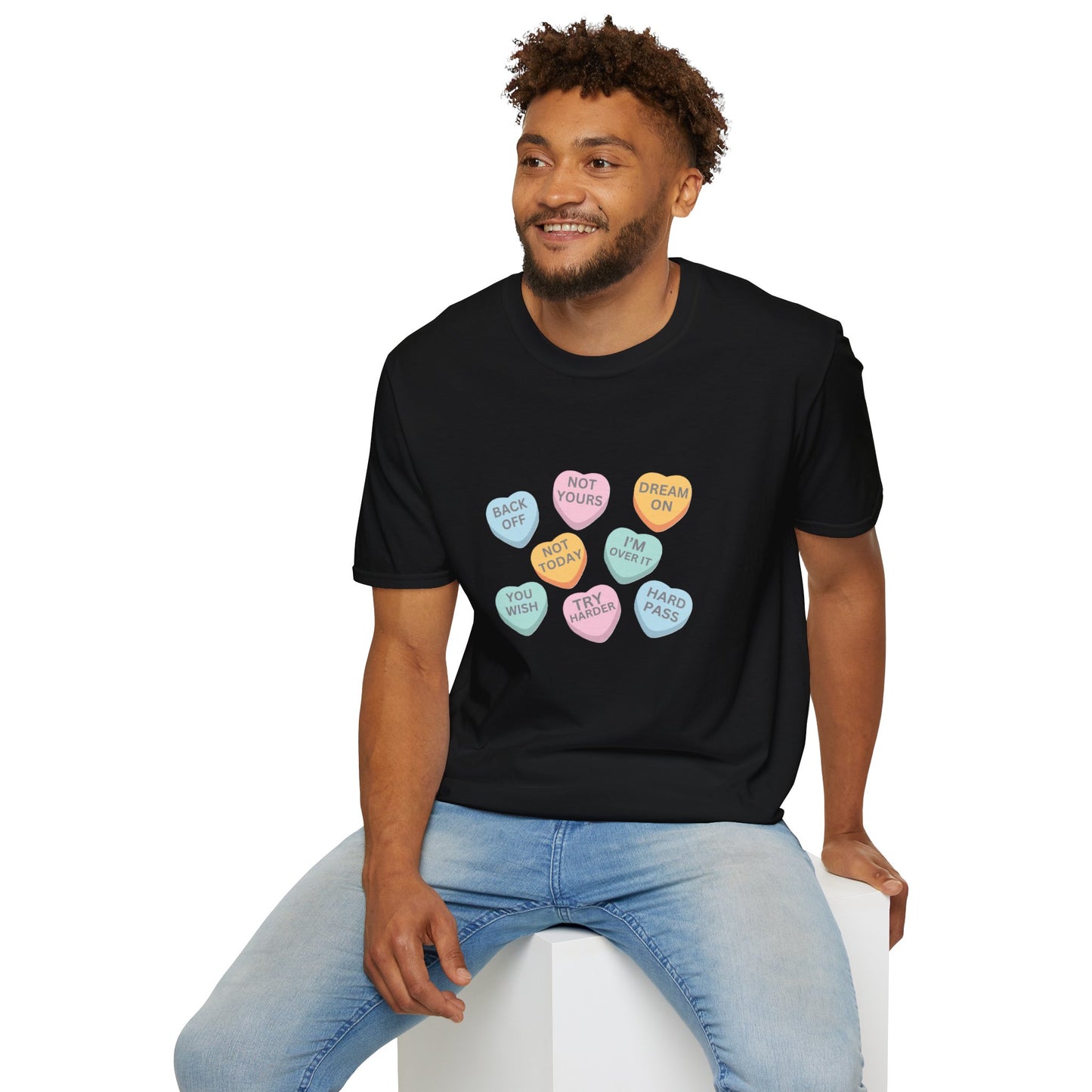 Man wearing a black t-shirt with colorful heart-shaped candy designs on a white background