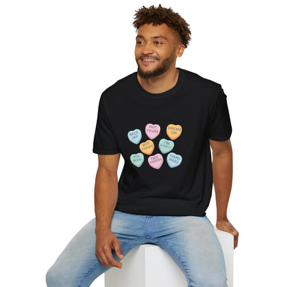 Man wearing a black t-shirt with colorful heart-shaped candy designs on a white background