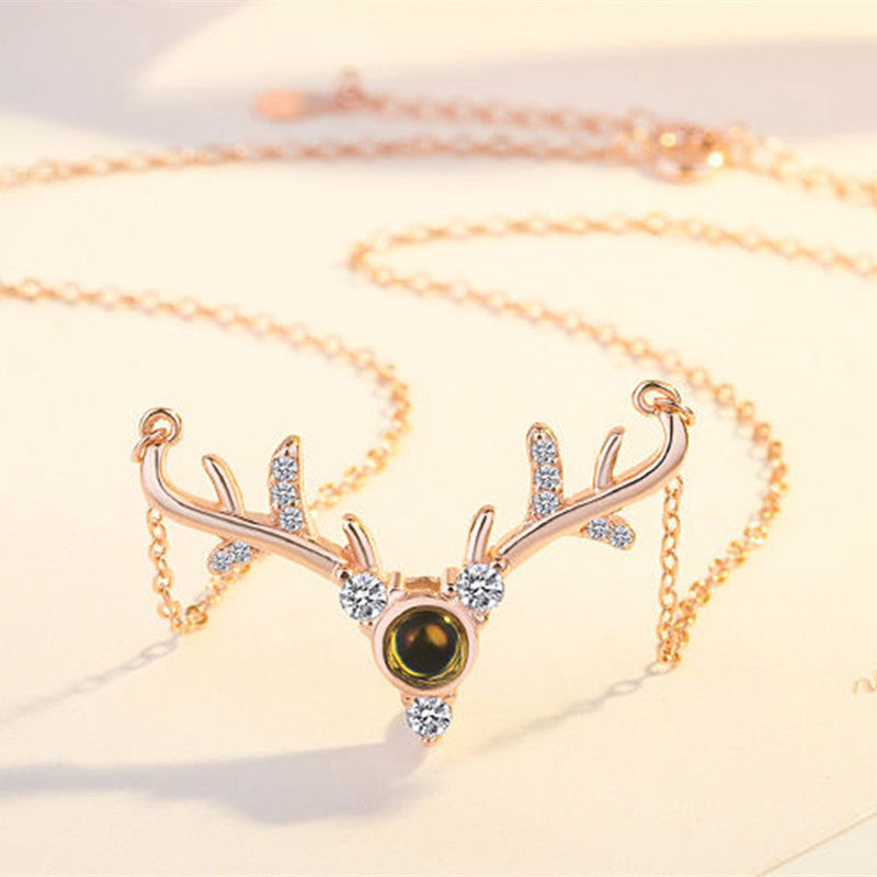 f26440ea1b12ad972827f0092c91c704 Elevate your holiday style with our Magical 100 "I Love You" Christmas Deer Necklace. Designed to enchant and delight, this necklace features a unique Christmas deer charm and a powerful reminder of love with our "I Love You" message hidden within the charms.