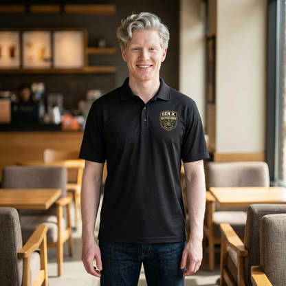 Man wearing a black polo shirt with a logo in a casual setting