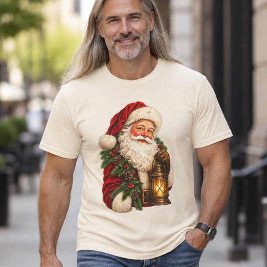 A man with long gray hair walking on a city street wearing a cream-colored t-shirt with a graphic of Santa Claus holding a lantern, paired with blue jeans.