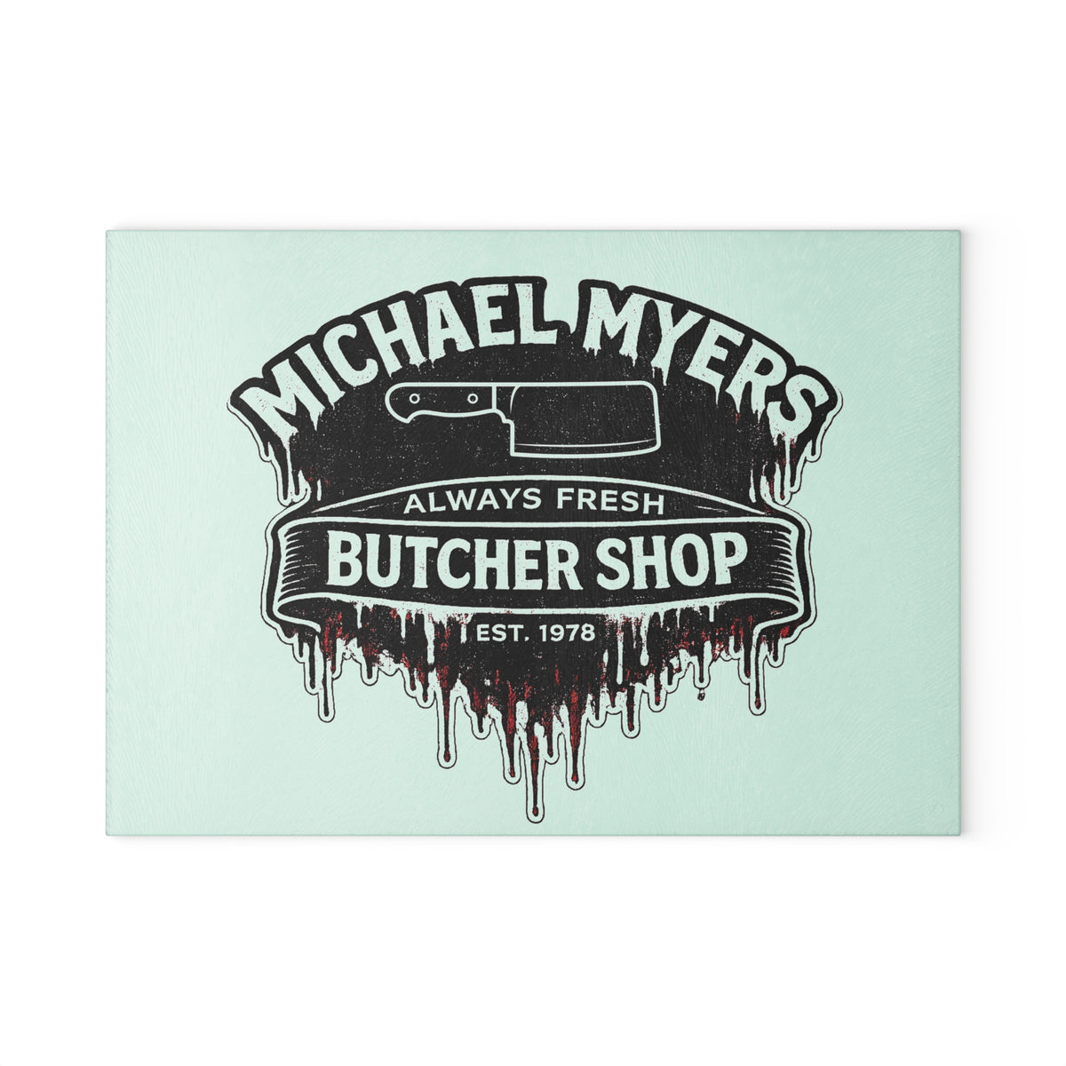 Bring a chilling touch of horror-inspired style to your kitchen with the Michael Myers Butcher Shop Glass Cutting Board. Designed for fans of classic slasher movies and spooky kitchen décor, this bold cutting board combines everyday functionality with a dark, Halloween-inspired aesthetic.