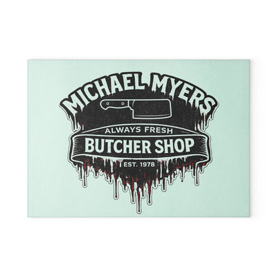 Bring a chilling touch of horror-inspired style to your kitchen with the Michael Myers Butcher Shop Glass Cutting Board. Designed for fans of classic slasher movies and spooky kitchen décor, this bold cutting board combines everyday functionality with a dark, Halloween-inspired aesthetic.