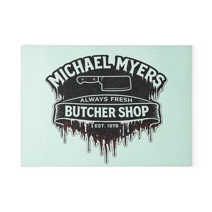 Bring a chilling touch of horror-inspired style to your kitchen with the Michael Myers Butcher Shop Glass Cutting Board. Designed for fans of classic slasher movies and spooky kitchen décor, this bold cutting board combines everyday functionality with a dark, Halloween-inspired aesthetic.