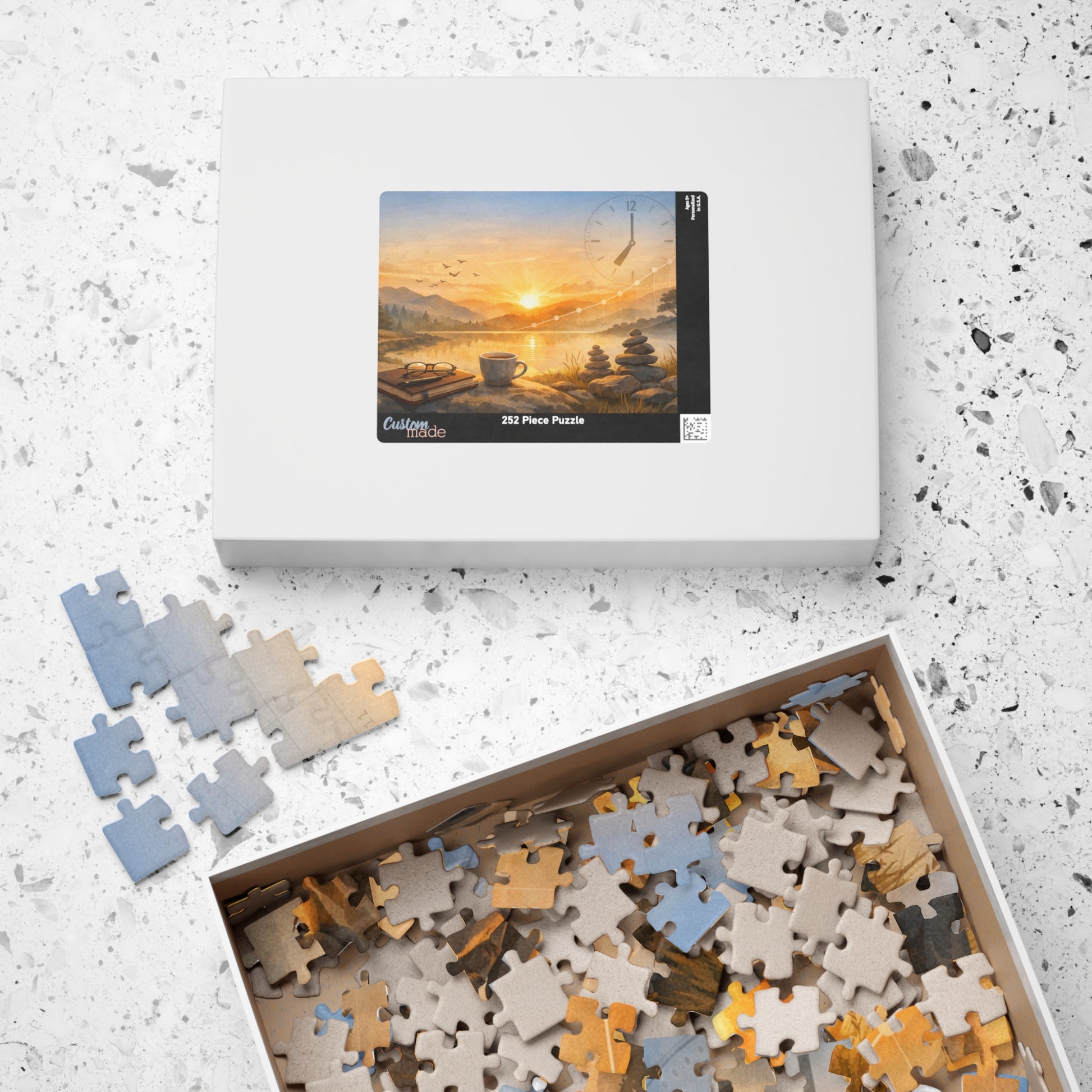 Puzzle set with pieces and packaging on a textured surface