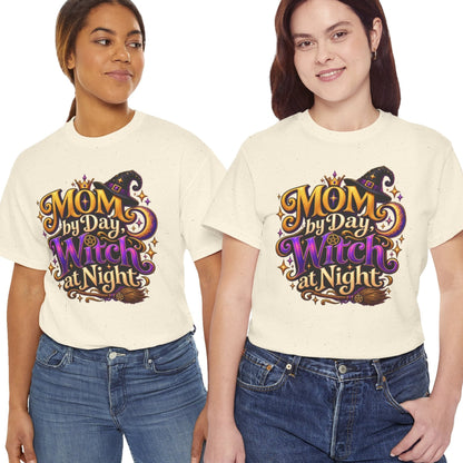 Two women modeling matching cream-colored graphic t-shirts with a purple and gold 'MOM My Day Witch at Night' design, paired with blue jeans against a plain white background.