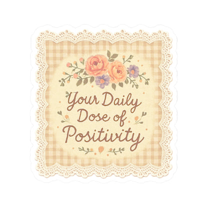 Decorative pillow with floral design and text 'Your Daily Dose of Positivity' on a checkered background.