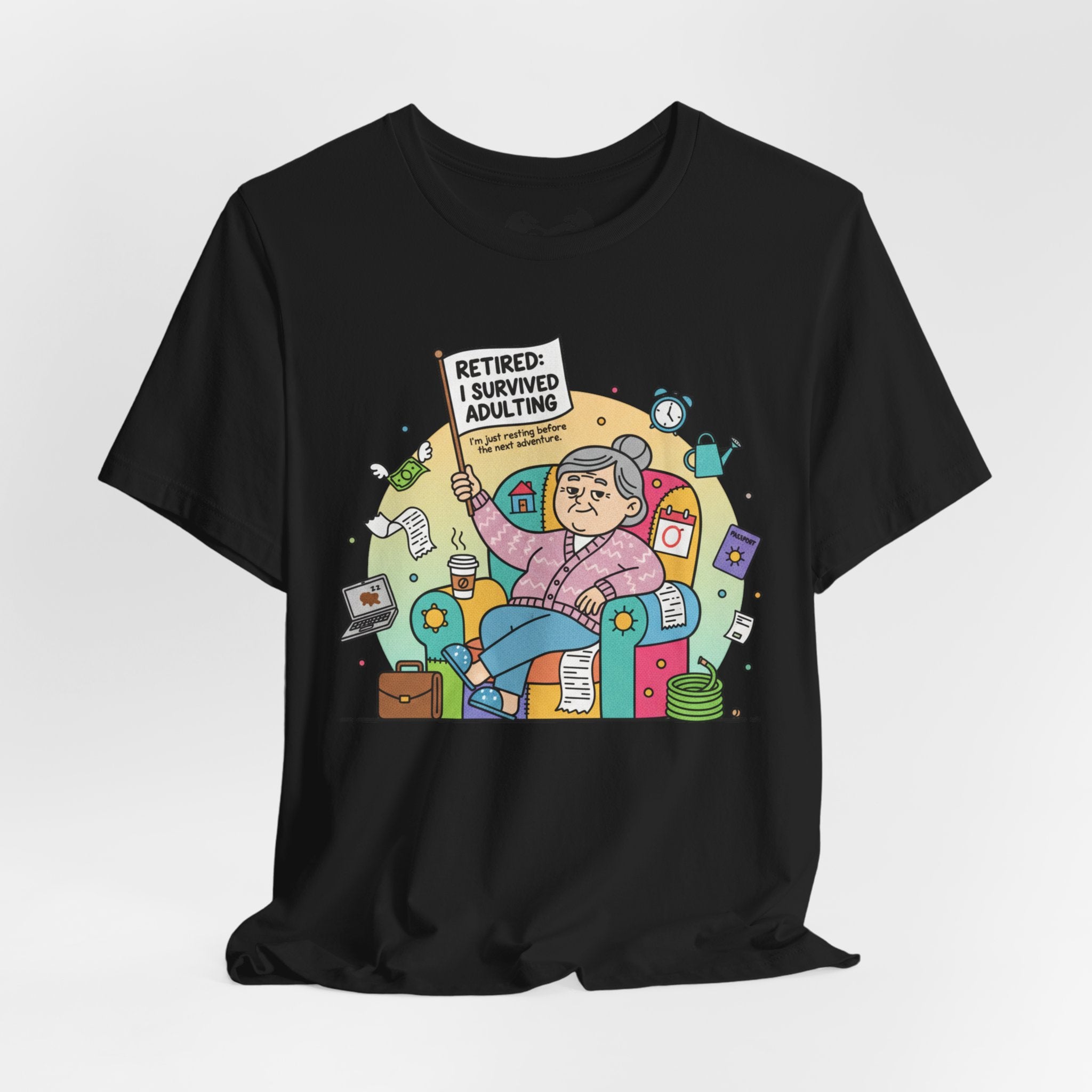 Black t-shirt with a colorful graphic of an elderly woman holding a 'Retired: I Survived Adulting' sign on a white background.