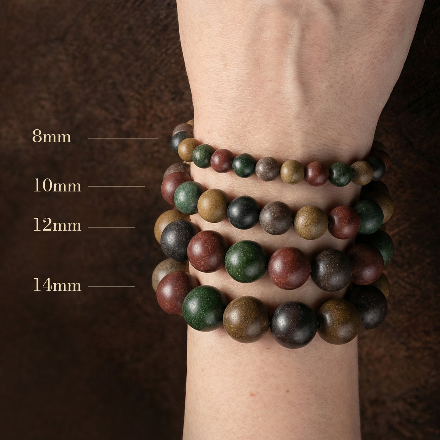 Stack of beaded bracelets on a wrist with size labels.