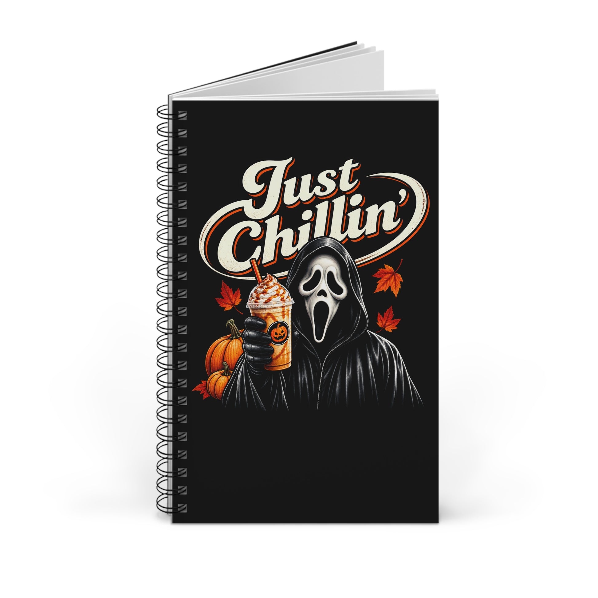 A spiral-bound notebook with a black cover featuring a Ghostface-style hooded figure in a white mask, holding a pumpkin and an iced coffee, with the words 'Just Chillin'' in large white script. The notebook is photographed on a clean white background.
