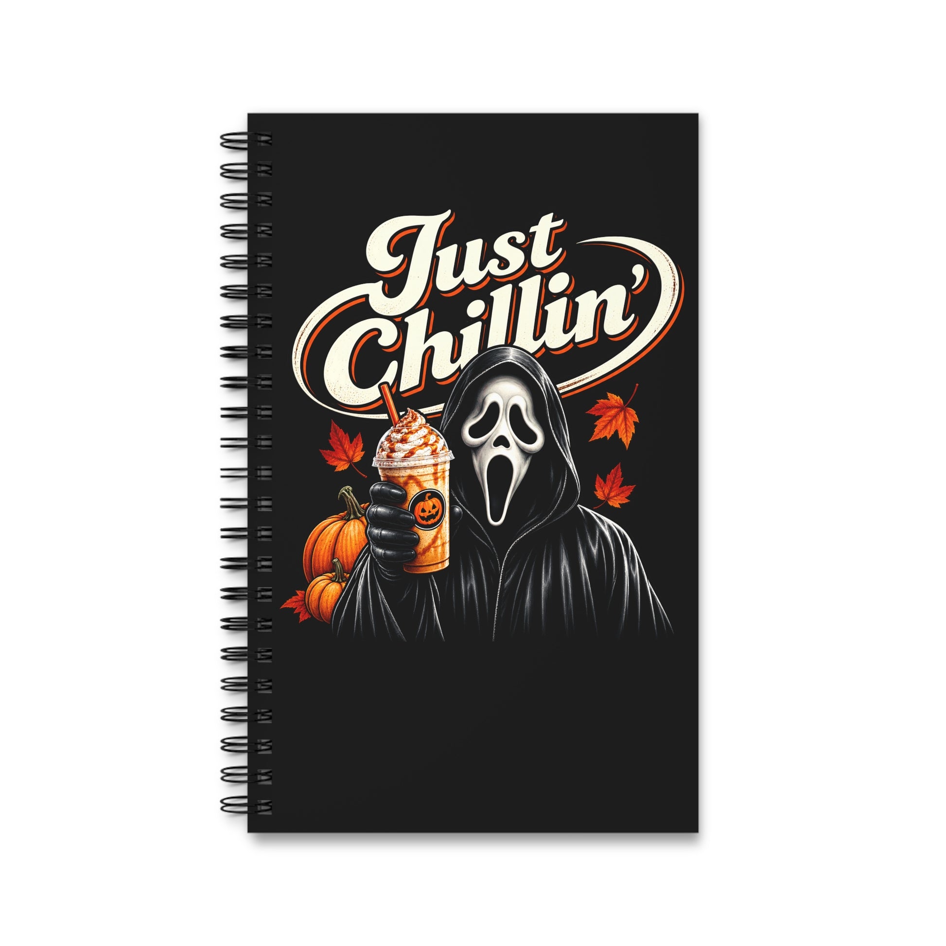 A black spiral-bound notebook featuring a Halloween-themed graphic with the text 'Just Chillin'', a Ghostface-like hooded figure, pumpkins, autumn leaves, and a drink, shown on a plain white background.