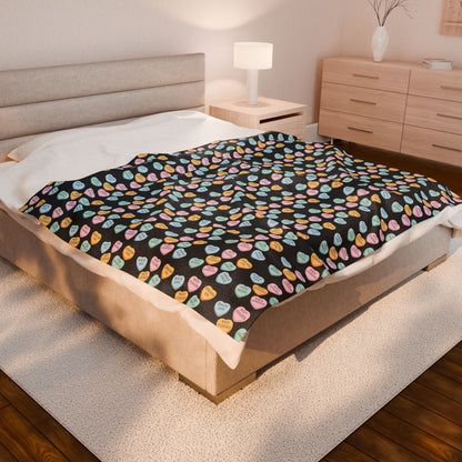 Bed with a colorful patterned blanket in a bedroom setting