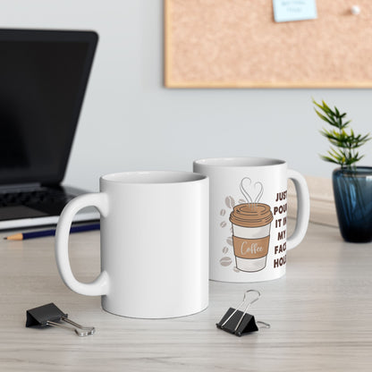 Two white mugs on a desk with a laptop and plant in the background